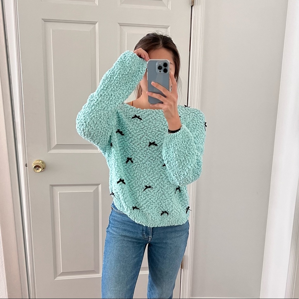 Turquoise sweater with black ribbons